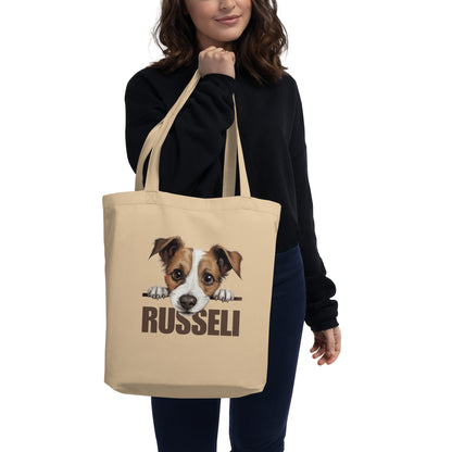 Nainen olallaan jackrussellinterrier-kangaskassi tekstillä "russeli".