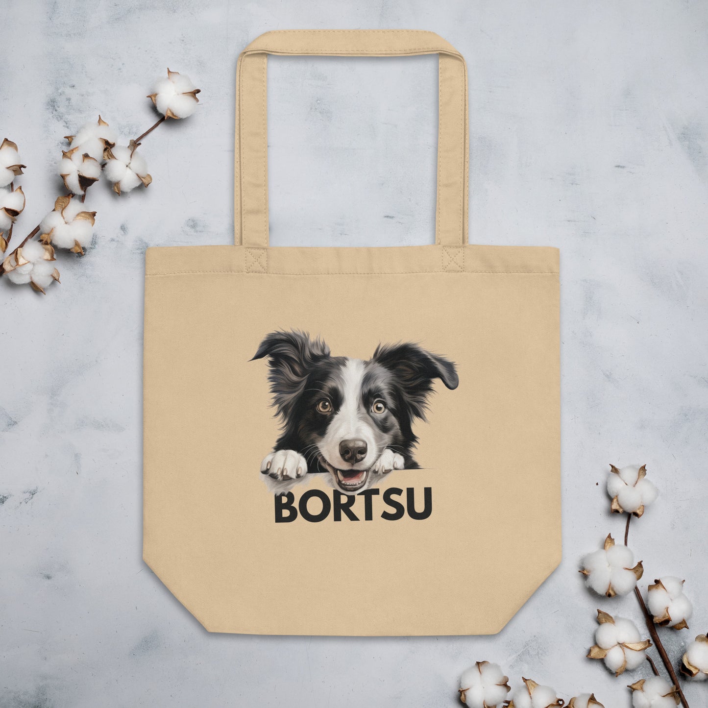 Beige kangaskassi, jossa kurkkaavan bordercollien kuva ja tumma "bortsu"-teksti.
