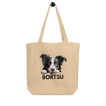 Bordercollie-kangaskassissa on pitkä hihna, jonka avulla sitä voi pitää olalla tai laittaa roikkumaan.