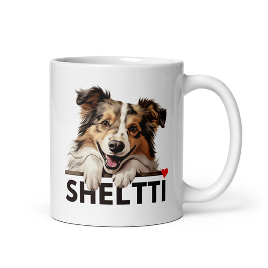 Valkoinen muki, jossa shetlanninlammaskoiran kuva ja tumma teksti "sheltti".