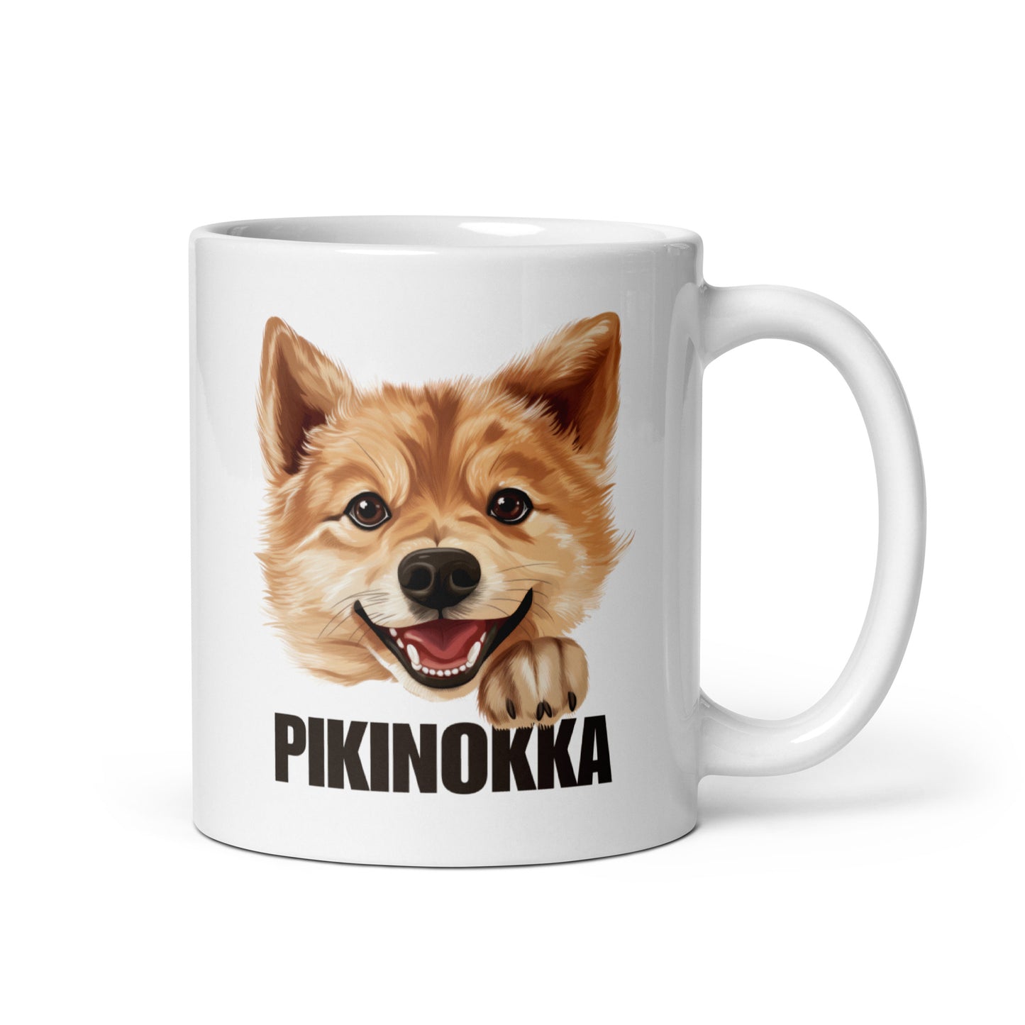 Lähikuva kiiltävänvalkoisesta mukista, jossa suomenpystykorvan kuva ja tumma teksti "pikinokka".