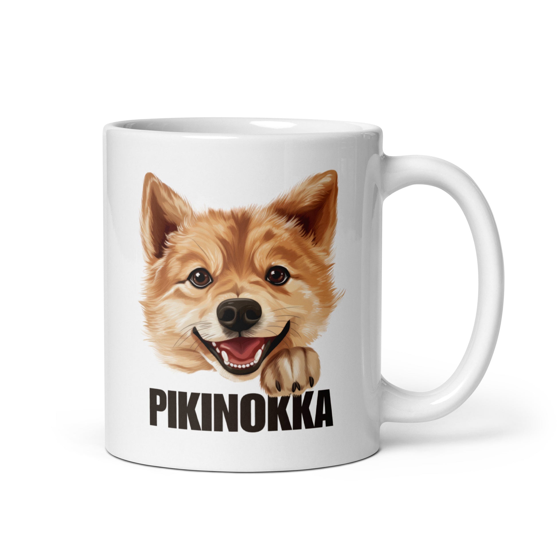 Lähikuva kiiltävänvalkoisesta mukista, jossa suomenpystykorvan kuva ja tumma teksti "pikinokka".
